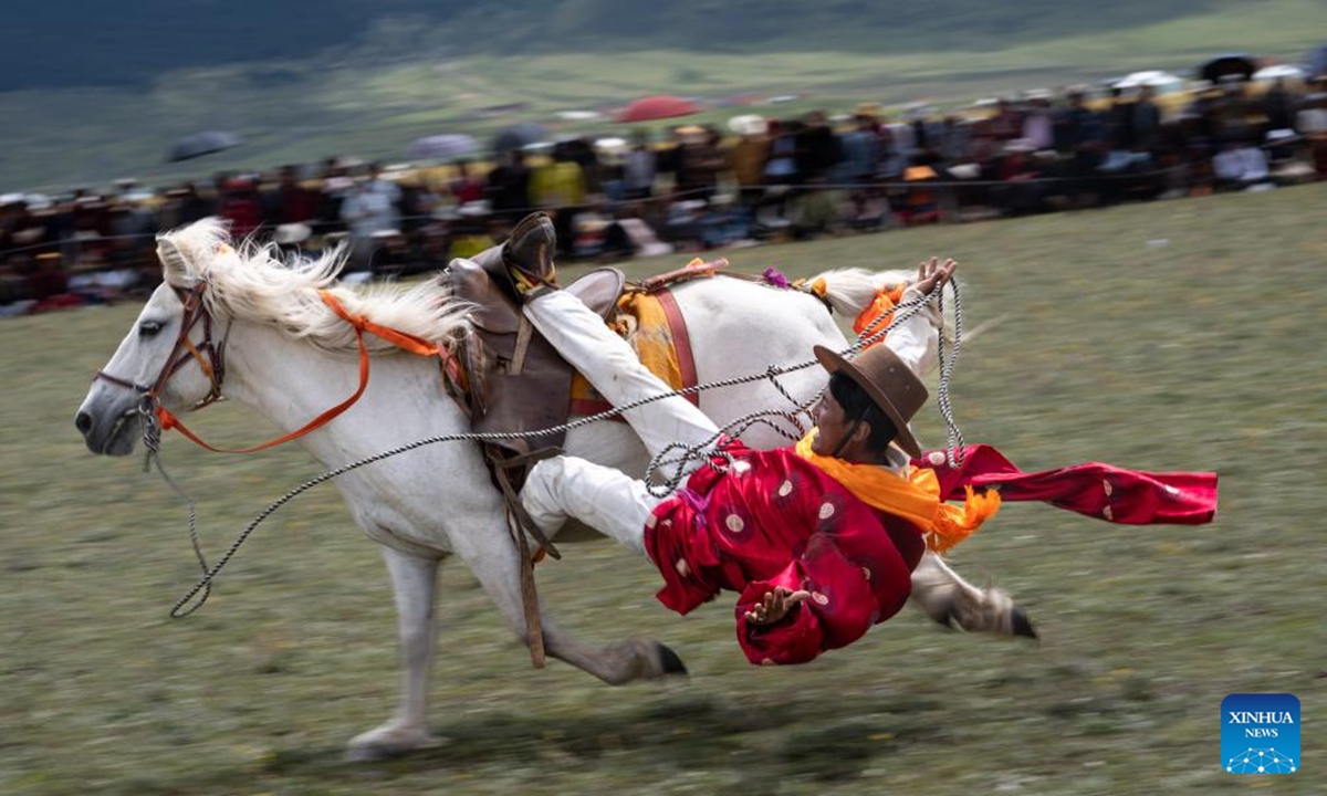 A rider demonstrates his skills at a racecourse in Litang County, the Tibetan Autonomous Prefecture of Garze, southwest China's Sichuan Province, July 30, 2024. A horse racing event kicked off in Litang County on Tuesday, attracting nearly 1,000 herdsmen from across the county to participate in a variety of activities. (Photo: Xinhua)