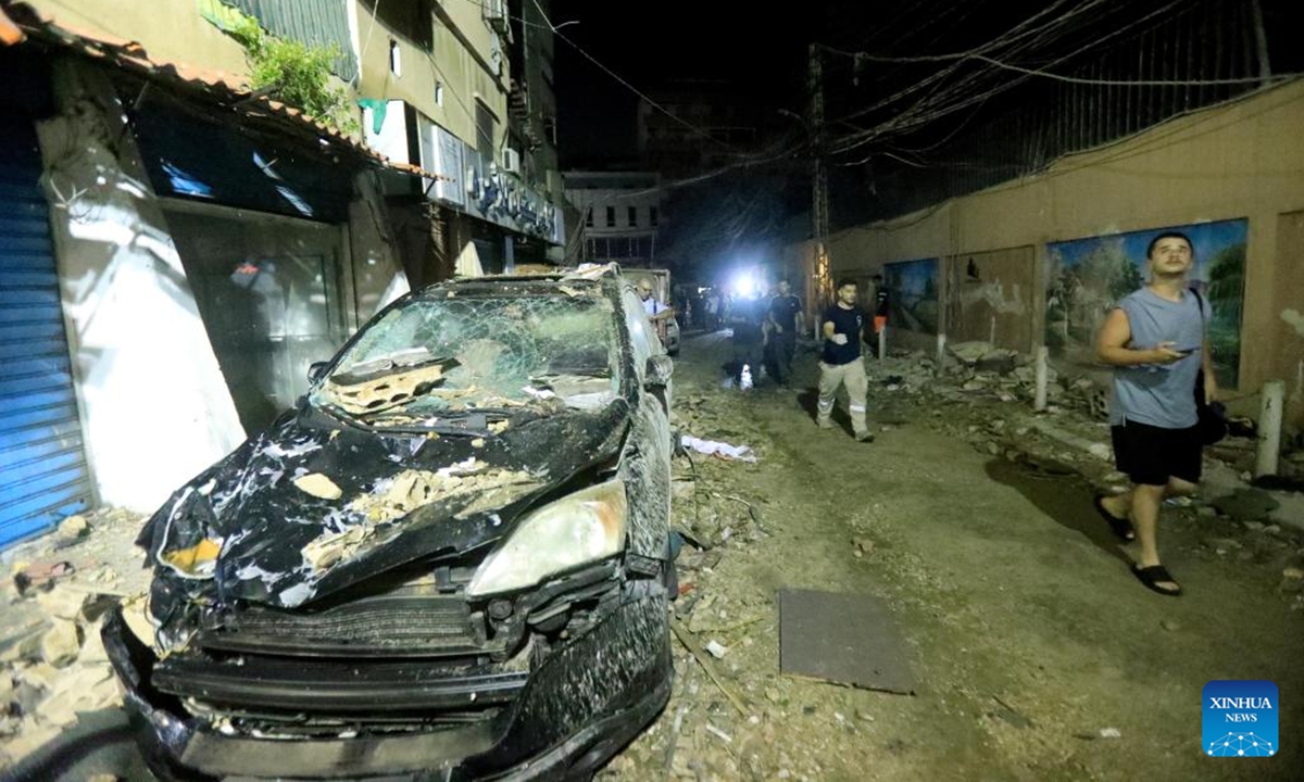 A vehicle at the roadside is seen damaged in an Israeli strike on a nearby building in the southern suburb of Beirut, Lebanon, on July 30, 2024. Israel's army announced on Tuesday that it killed Hezbollah's top military commander, Fouad Shokor, in an airstrike in Beirut, saying the assassination was a retaliation for a cross-border rocket that killed 12 youngsters on Saturday. (Photo: Xinhua)