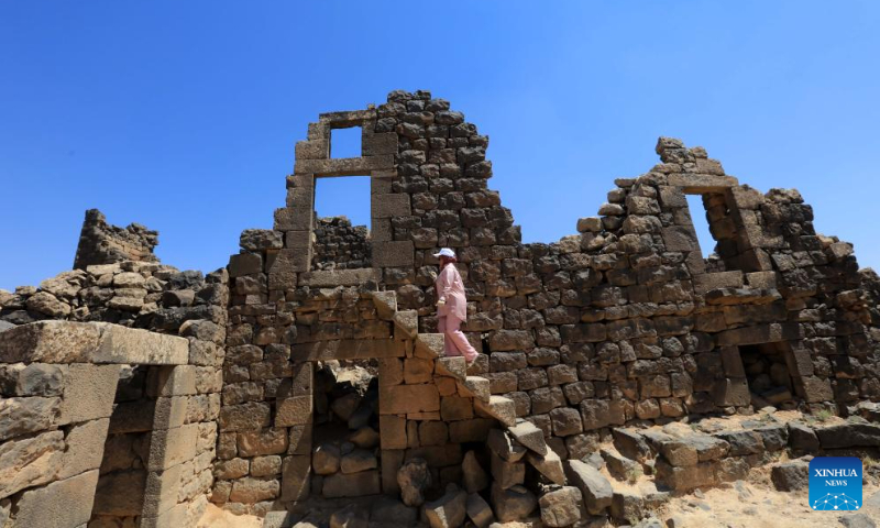 A woman walks on cantilevered stairway of a house at the archaeological site of Umm al-Jimal in northern Jordan, Aug. 13, 2024. Umm al-Jimal, located in northern Jordan, is one of the country's significant cultural heritage sites which was inscribed on the World Heritage List by the United Nations Educational, Scientific and Cultural Organization (UNESCO) in 2024. (Photo: Xinhua)