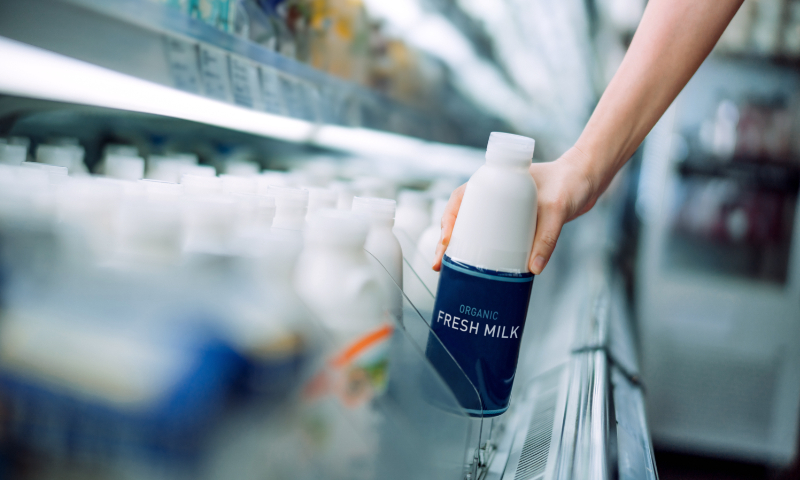 A customer is selecting imported dairy products at a supermarket File photo: VCG