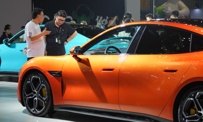 A visitor learns about an electric vehicle (EV) from an employee at the 2024 China Auto Show in Shanghai on August 8, 2024. The auto show runs from August 8 to 11 at Shanghai’s National Exhibition and Convention Center. With an exhibition area of 40,000 square meters, this year’s expo showcases more than 200 smart EV models. Photo: Lu Ting/GT