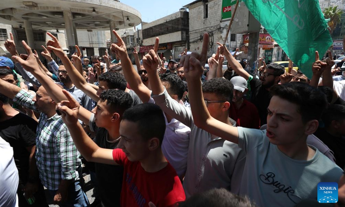 People take part in a protest against the assassination of Hamas Politburo Chief Ismail Haniyeh in the West Bank city of Hebron, on July 31, 2024. Palestinian President Mahmoud Abbas on Wednesday denounced the assassination of Haniyeh as a cowardly act and a dangerous development, calling on the Palestinian people to unite, be patient and steadfast in the face of Israel, according to the Palestinian official news agency WAFA. (Photo: Xinhua)