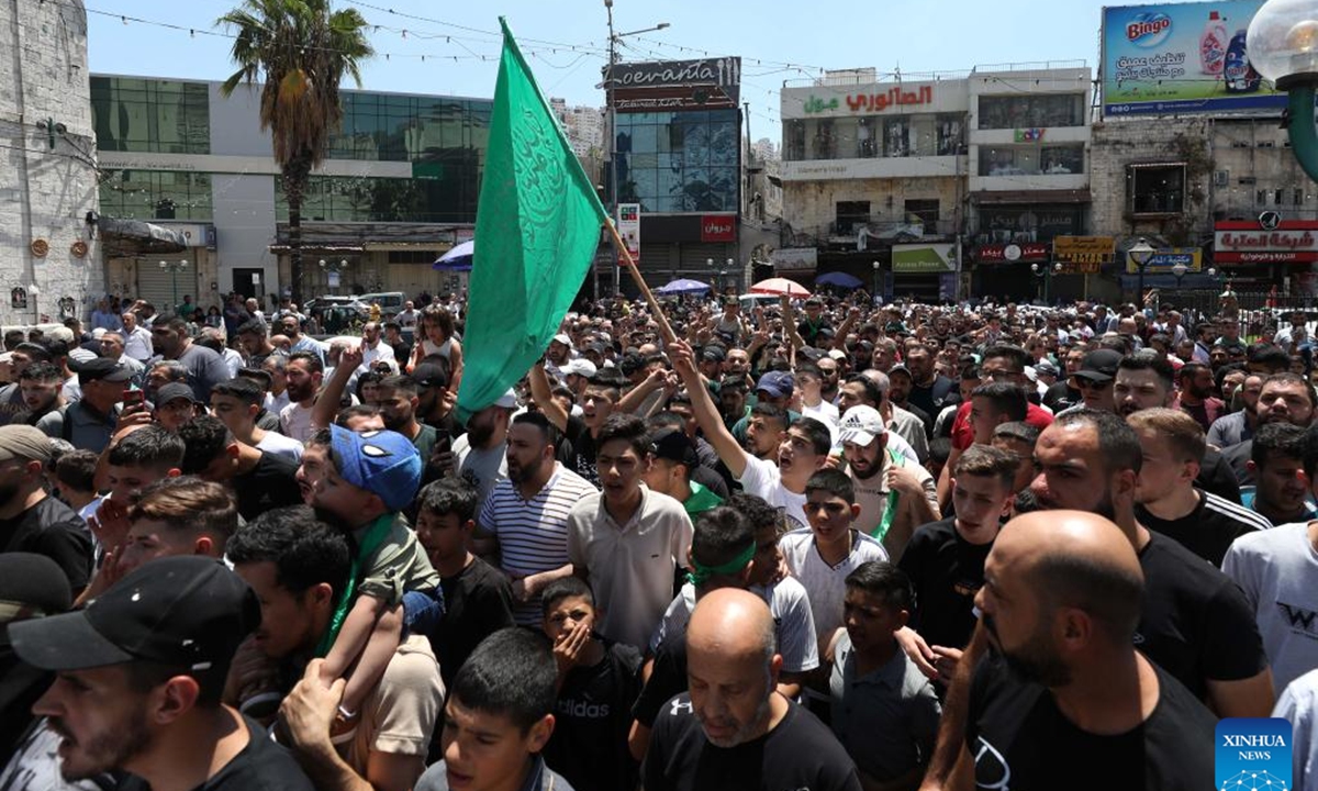 People take part in a protest against the assassination of Hamas Politburo Chief Ismail Haniyeh in the West Bank city of Hebron, on July 31, 2024. Palestinian President Mahmoud Abbas on Wednesday denounced the assassination of Haniyeh as a cowardly act and a dangerous development, calling on the Palestinian people to unite, be patient and steadfast in the face of Israel, according to the Palestinian official news agency WAFA. (Photo: Xinhua)