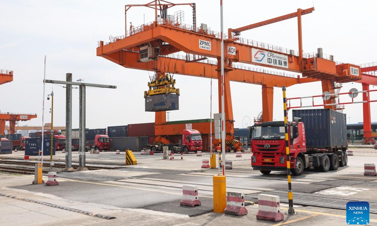 A vehicle transfers a container at the dry port of the New International Land-Sea Trade Corridor in the Chongqing International Logistics Hub Park in Shapingba District of Chongqing, southwest China, July 30, 2024. Chongqing International Logistics Hub Park, along with its 62 freight train routes, has risen to be a major hub of international freight trains in the country's western region. (Photo: Xinhua)