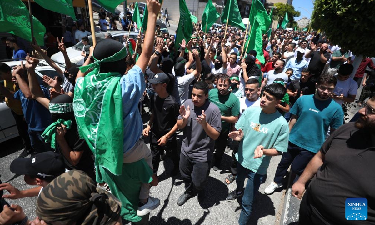 People take part in a protest against the assassination of Hamas Politburo Chief Ismail Haniyeh in the West Bank city of Hebron, on July 31, 2024. Palestinian President Mahmoud Abbas on Wednesday denounced the assassination of Haniyeh as a cowardly act and a dangerous development, calling on the Palestinian people to unite, be patient and steadfast in the face of Israel, according to the Palestinian official news agency WAFA. (Photo: Xinhua)