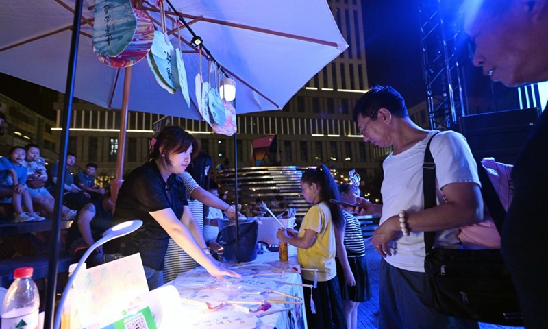 Visitors choose products during the 5th Tianjin Nighttime Life Festival in north China's Tianjin Municipality, Aug. 2, 2024. The 5th Tianjin Nighttime Life Festival began here on Friday night and will last about one month. People can enjoy night markets, music shows, sports games and art exhibitions during the festival. Photo: Xinhua