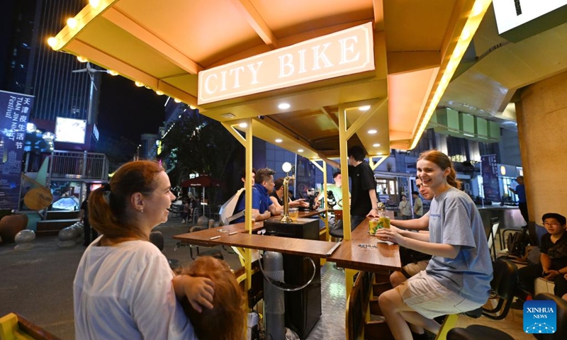 Visitors relax during the 5th Tianjin Nighttime Life Festival in north China's Tianjin Municipality, Aug. 2, 2024. The 5th Tianjin Nighttime Life Festival began here on Friday night and will last about one month. People can enjoy night markets, music shows, sports games and art exhibitions during the festival. Photo: Xinhua