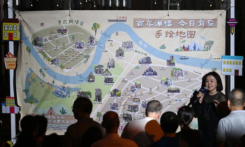 A staff member introduces the map that shows the location of western-style buildings at the opening ceremony of the 5th Tianjin Nighttime Life Festival in north China's Tianjin Municipality, Aug. 2, 2024. The 5th Tianjin Nighttime Life Festival began here on Friday night and will last about one month. People can enjoy night markets, music shows, sports games and art exhibitions during the festival. Photo: Xinhua