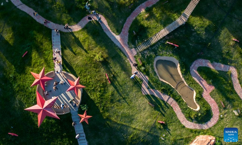 An aerial drone photo taken on Aug. 1, 2024 shows tourists visiting the Yangjiadian Village in Guyuan City, northwest China's Ningxia Hui Autonomous Region. Relying on abundant red tourism resources of the Liupan Mountain, local authorities in Yangjiadian have actively developed homestay and rural tourism to advance rural revitalization. Photo: Xinhua