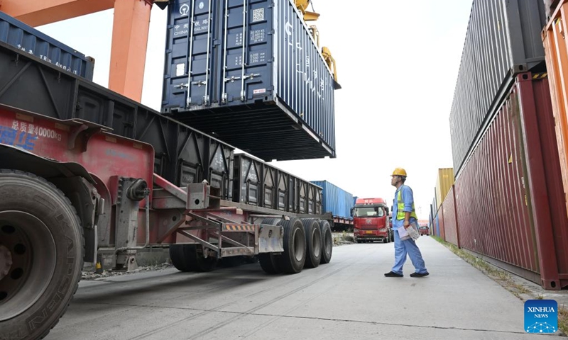 A staff member guides the loading work at the logistics base of Hefei north railway station in Hefei, east China's Anhui Province, Aug. 1, 2024. A total of 380 China-Europe freight trains departing from Hefei between January and July this year, marking a 3 percent increase from the previous year. Photo: Xinhua