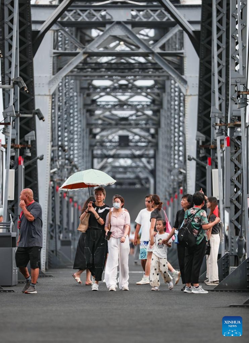 Tourists visit the Broken Bridge over the Yalu River in Dandong City, northeast China's Liaoning Province, Aug. 2, 2024. Tourism service has resumed as the water level in the Yalu River recedes and the riverside roads are reopened to traffic. Photo: Xinhua