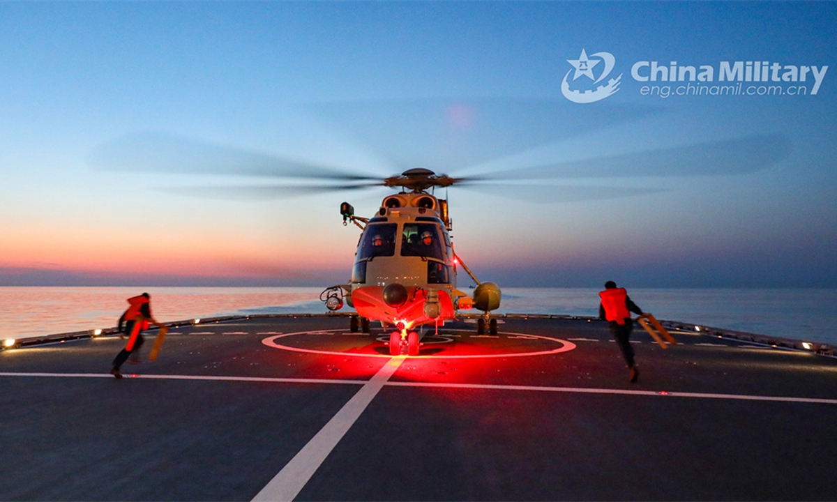 A ship-borne helicopter attached to a combat support ship flotilla under the PLA Navy conducts nighttime take-off and landing training during a multi-subject maritime training exercise on June 6, 2024. (eng.chinamil.com.cn/Photo by Yu Peng)