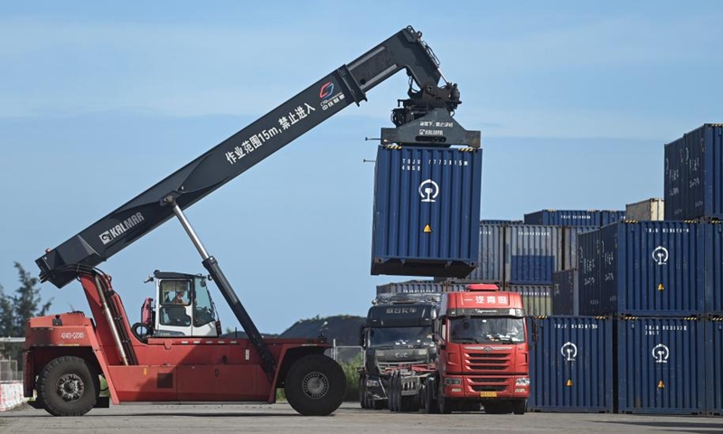 A staff member operates a crane to load a container onto a truck at a railway container terminal in Qinzhou, south China's Guangxi Zhuang Autonomous Region, Aug. 1, 2024. As of Aug. 2 this year, more than 500,000 twenty-foot equivalent unit (TEU) containers for rail-sea intermodal transportation have been delivered via the New International Land-Sea Trade Corridor, the highest level for the same period in all years. The New International Land-Sea Trade Corridor, jointly built by provincial-level regions in western China and ASEAN members, expanded its reach to 490 ports across 120 countries and regions, according to data released in January by southwest China's Chongqing Municipality, the corridor's operational hub. Photo: Xinhua