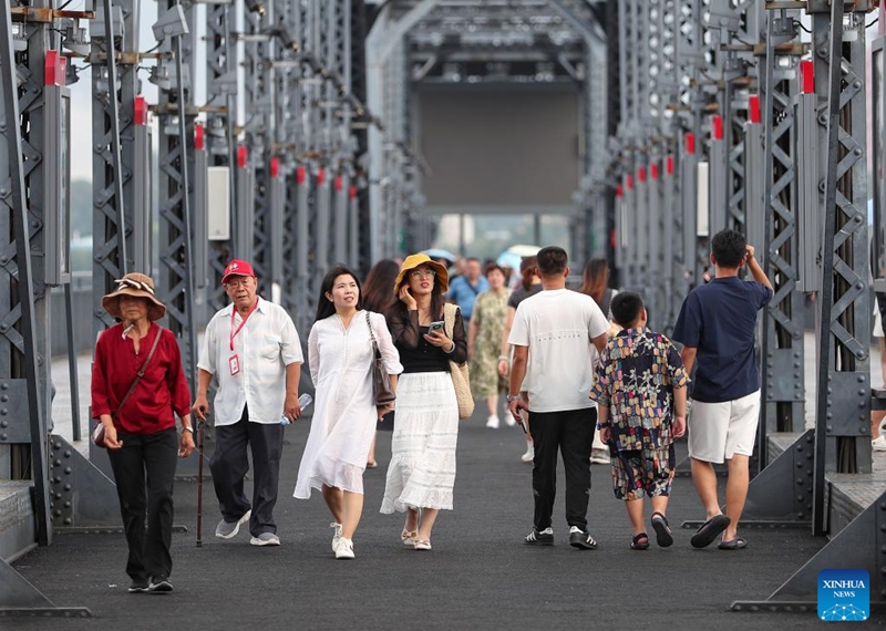 Tourists visit the Broken Bridge over the Yalu River in Dandong City, northeast China's Liaoning Province, Aug. 2, 2024. Tourism service has resumed as the water level in the Yalu River recedes and the riverside roads are reopened to traffic. Photo: Xinhua