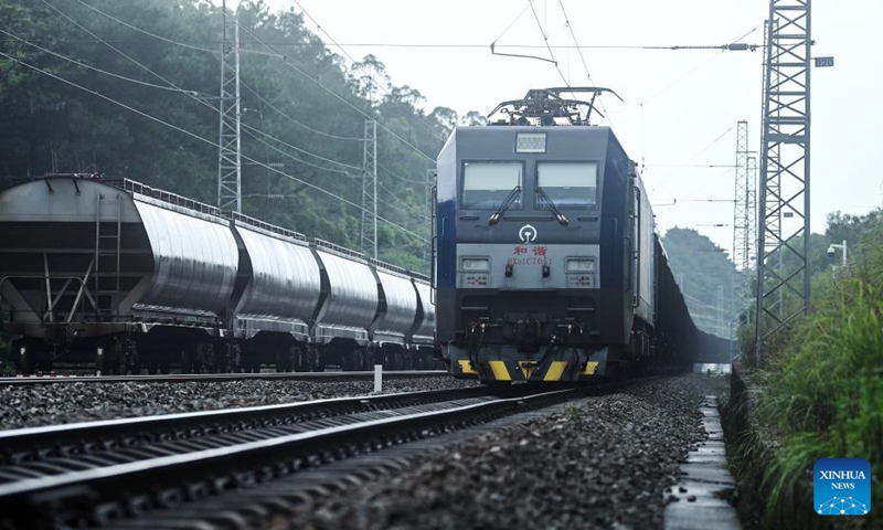 Two freight trains pass each other near a station on the Yongbei Railway Line of the New International Land-Sea Trade Corridor, Aug. 2, 2024. As of Aug. 2 this year, more than 500,000 twenty-foot equivalent unit (TEU) containers for rail-sea intermodal transportation have been delivered via the New International Land-Sea Trade Corridor, the highest level for the same period in all years. The New International Land-Sea Trade Corridor, jointly built by provincial-level regions in western China and ASEAN members, expanded its reach to 490 ports across 120 countries and regions, according to data released in January by southwest China's Chongqing Municipality, the corridor's operational hub.  Photo: Xinhua