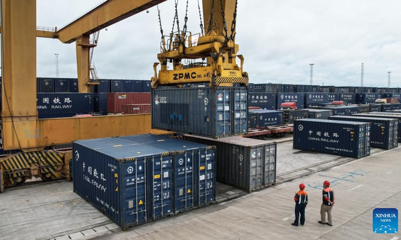 Staff members watch over the loading of containers at Nanning International Railway Port in Nanning, south China's Guangxi Zhuang Autonomous Region, July 31, 2024. As of Aug. 2 this year, more than 500,000 twenty-foot equivalent unit (TEU) containers for rail-sea intermodal transportation have been delivered via the New International Land-Sea Trade Corridor, the highest level for the same period in all years. The New International Land-Sea Trade Corridor, jointly built by provincial-level regions in western China and ASEAN members, expanded its reach to 490 ports across 120 countries and regions, according to data released in January by southwest China's Chongqing Municipality, the corridor's operational hub. Photo: Xinhua