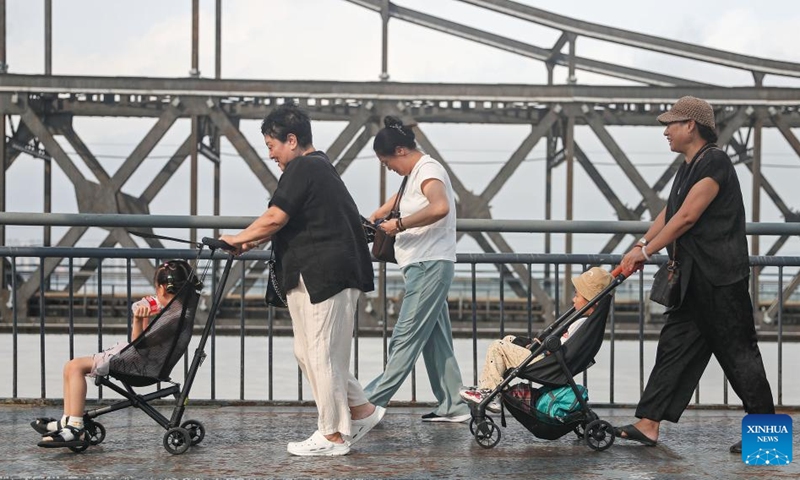 Tourists visit the Broken Bridge over the Yalu River in Dandong City, northeast China's Liaoning Province, Aug. 2, 2024. Tourism service has resumed as the water level in the Yalu River recedes and the riverside roads are reopened to traffic. Photo: Xinhua