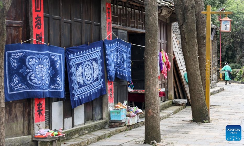 A villager walks in Tianlong Tunpu ancient town in Pingba District of Anshun City, southwest China's Guizhou Province, July 25, 2024. In Anshun City, southwest China's Guizhou Province, ancient stone buildings and unique local traditions have made a cluster of villages popular tourist destinations for many visitors. The stone-structured Tunpu residential buildings were built in the Ming Dynasty (1368-1644), when some troops were sent to Anshun, where they built villages and turned the neighborhood into farmland for growing crops. Their descendants have lived there over generations, and formed the unique Tunpu culture which preserved distinctive customs, architectures, operas and costumes of ancient times. Photo: Xinhua