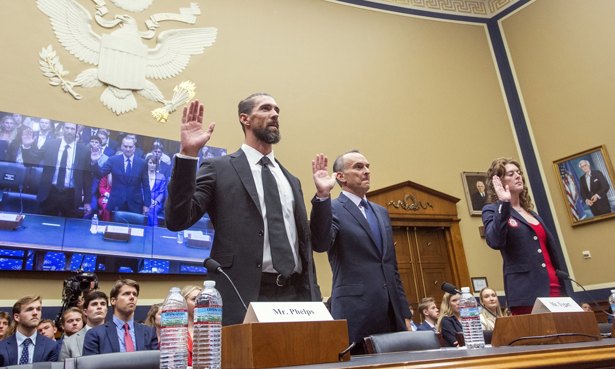 Michael Phelps (left), former Olympic athlete, Travis Tygart (center), Chief Executive Officer of the US Anti-Doping Agency, and Allison Schmitt, former Olympic athlete, are sworn in during a House Committee on anti-doping measures on June 25, 2024 in Washington DC. Photo: VCG