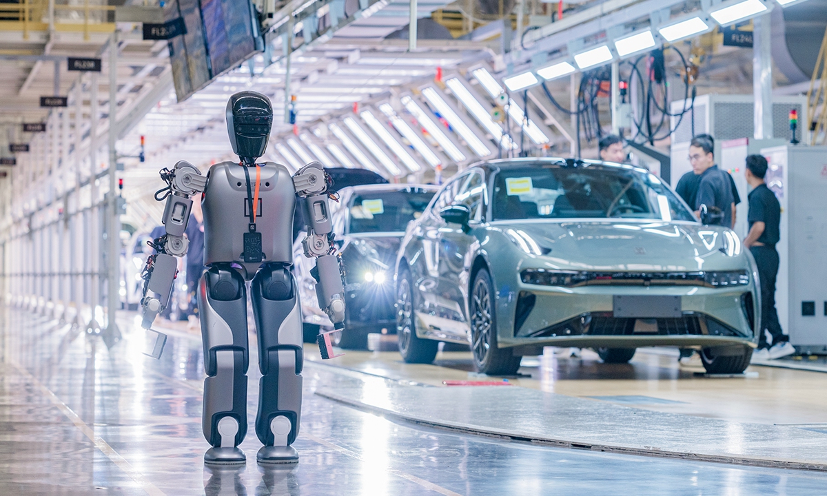 A humanoid robot walks at a 5G smart factory of Chinese automaker ZEEKR on August 5, 2024 in Ningbo, East China's Zhejiang Province. It is the factory's first humanoid robot 