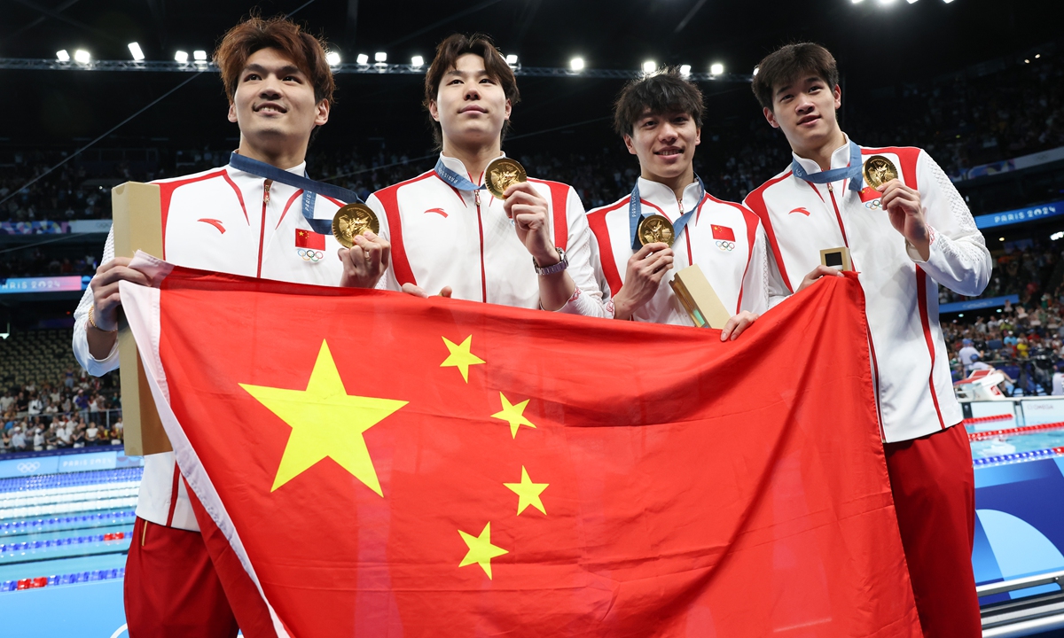 (From left) Chinese swimmers Xu Jiayu,<strong></strong> Qin Haiyang, Sun Jiajun and Pan Zhanle pose for a photo with their gold medals during the awards ceremony for the men's 4x100m medley relay at the Paris Olympics on August 4, 2024. Photo: VCG