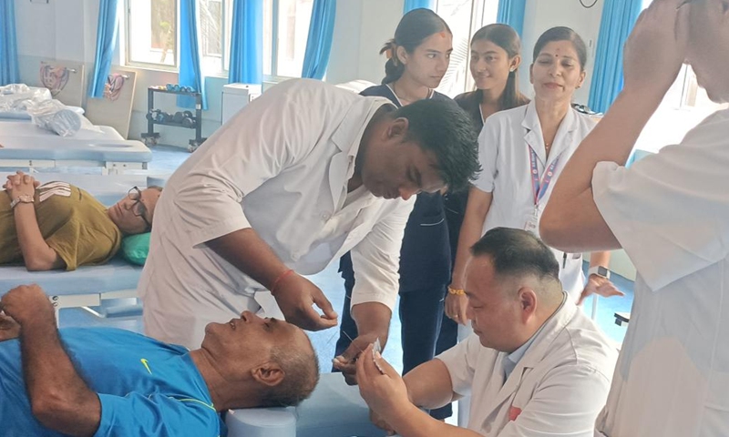 Doctors treat a patient at the international traditional Chinese medicine (TCM) rehabilitation and treatment center in Nepal, July 26, 2024. This international TCM rehabilitation and treatment center, the first of its kind in Nepal, was inaugurated here on Sunday. Photo: Xinhua