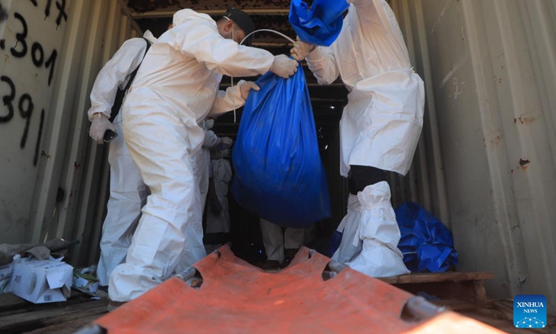 Workers remove bodies of unidentified Palestinians killed by the Israeli army in the southern Gaza Strip city of Khan Younis, on Aug. 5, 2024. Israel had returned the bodies of 89 Palestinians killed by the Israeli army in the Gaza Strip, the Hamas-run Gaza government media office said on Monday. (Photo: Xinhua)