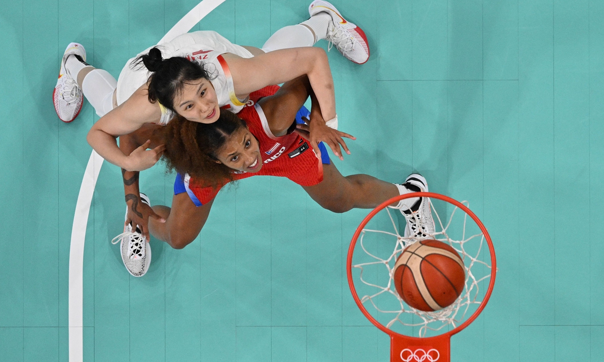 An overview shows China's #10 Zhang Ru (L) and Puerto Rico's #22 Arella Guirantes eye a rebound in the women's preliminary round group A basketball match between China and Puerto Rico during the Paris 2024 Olympic Games at the Pierre-Mauroy stadium in Villeneuve-d'Ascq, northern France, on August 3, 2024. Photo: VCG