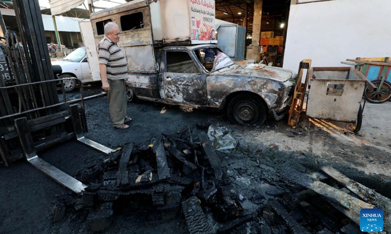 A man inspects a warehouse damaged during clashes between Palestinian protesters and Israeli settlers in the West Bank city of Nablus, on Aug. 5, 2024. (Photo: Xinhua)