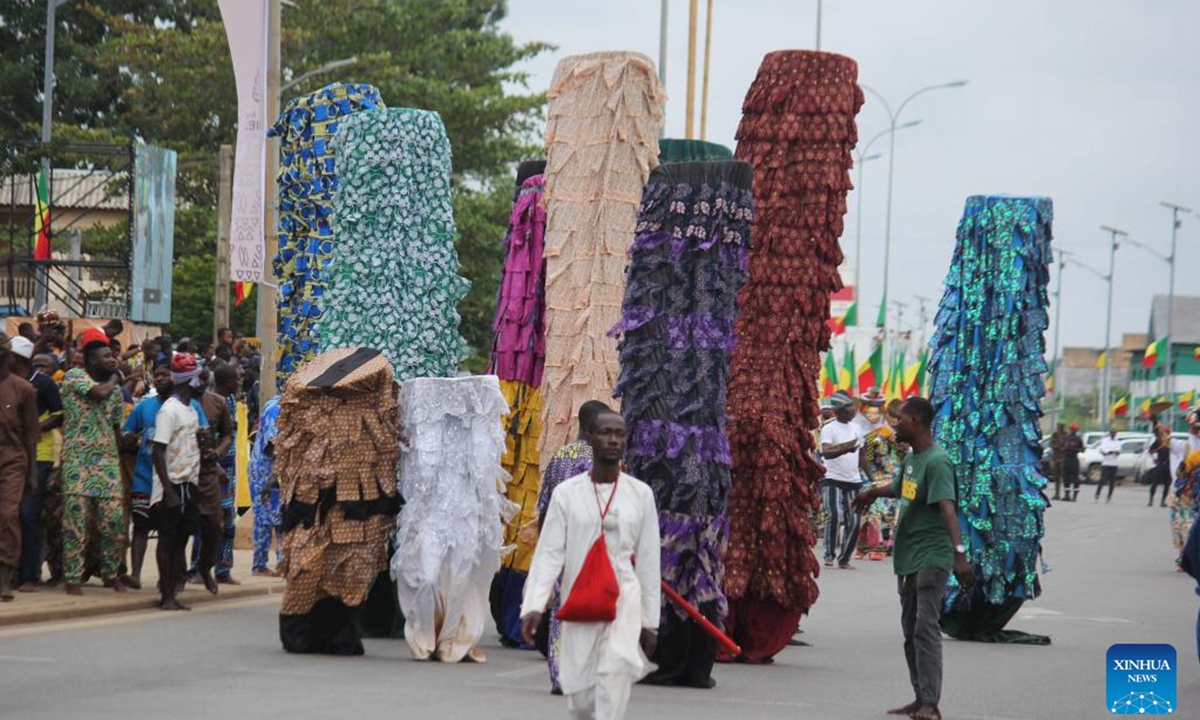 People in costumes perform in a mask parade during the Porto Novo Mask Festival in Porto Novo, Benin, Aug. 4, 2024. The festival was held here from Friday to Sunday to showcase the art and culture of Benin's traditional religion Vodun through a mask parade, concerts, seminars and other activities. (Photo: Xinhua)