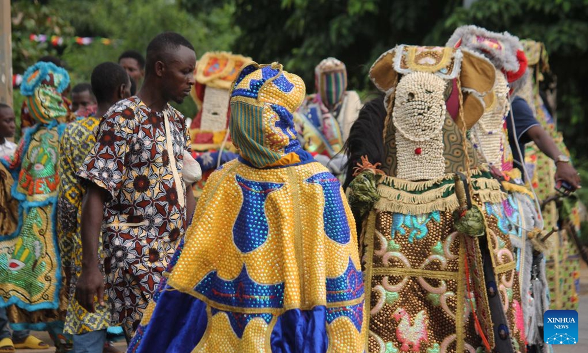 People in costumes perform in a mask parade during the Porto Novo Mask Festival in Porto Novo, Benin, Aug. 4, 2024. The festival was held here from Friday to Sunday to showcase the art and culture of Benin's traditional religion Vodun through a mask parade, concerts, seminars and other activities. (Photo: Xinhua)