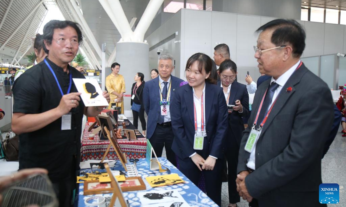 People visit a display showcasing intangible cultural heritage of southwest China's Yunnan province and Cambodia at the launching ceremony of the China-Cambodia Cultural Corridor in Siem Reap Angkor International Airport in northwest Cambodia on Aug. 6, 2024. The China-Cambodia Cultural Corridor was launched on Tuesday at Siem Reap Angkor International Airport in northwest Cambodia, a new push for the development of regional tourism. (Photo: Xinhua)