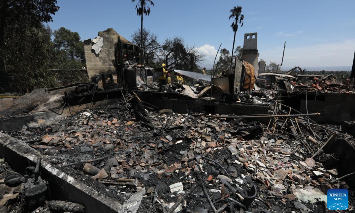 Firefighters work in an area affected by a brush fire, dubbed the Edgehill Fire, in San Bernardino County, California, the United States, on Aug. 6, 2024. Multiple homes were damaged or destroyed in a fast-moving brush fire in Southern California before firefighters managed to stop its progress, authorities said on Tuesday.  (Photo: Xinhua)