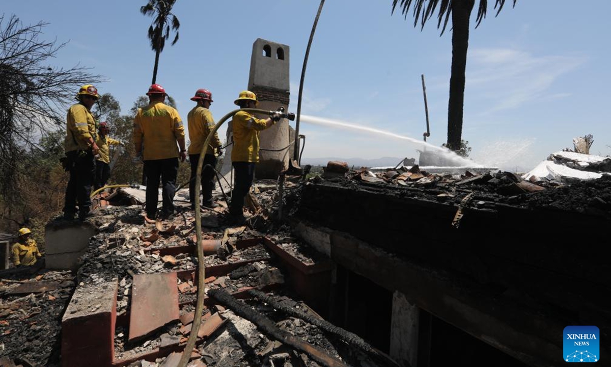 Firefighters work in an area affected by a brush fire, dubbed the Edgehill Fire, in San Bernardino County, California, the United States, on Aug. 6, 2024. Multiple homes were damaged or destroyed in a fast-moving brush fire in Southern California before firefighters managed to stop its progress, authorities said on Tuesday.  (Photo: Xinhua)