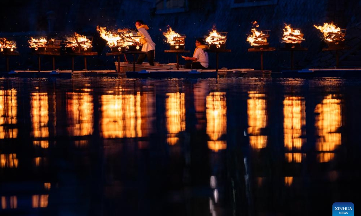 Staff members put wooden chips bearing blessing messages into braziers in commemoration of atomic bombing victims at Hiroshima Peace Memorial Park in Hiroshima, Japan, Aug. 5, 2024. As Japan marked the anniversary of atomic bombing on the western city of Hiroshima on Tuesday, people from across the nation gathered to protest the government's accelerated arms build-up, urging it to stick to peace.  (Photo: Xinhua)