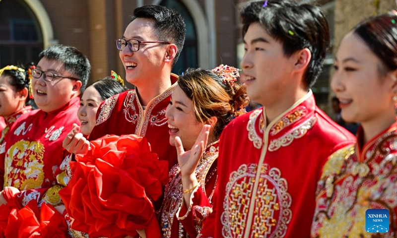 URUMQI, Aug. 10, 2024 (Xinhua) -- Newlywed couples attend a group wedding at the Xinjiang International Grand Bazaar in Urumqi, northwest China's Xinjiang Uygur Autonomous Region, Aug. 10, 2024. The group wedding was held here on Saturday to mark the Qixi Festival, also known as Chinese Valentine's Day. Photo: Xinhua