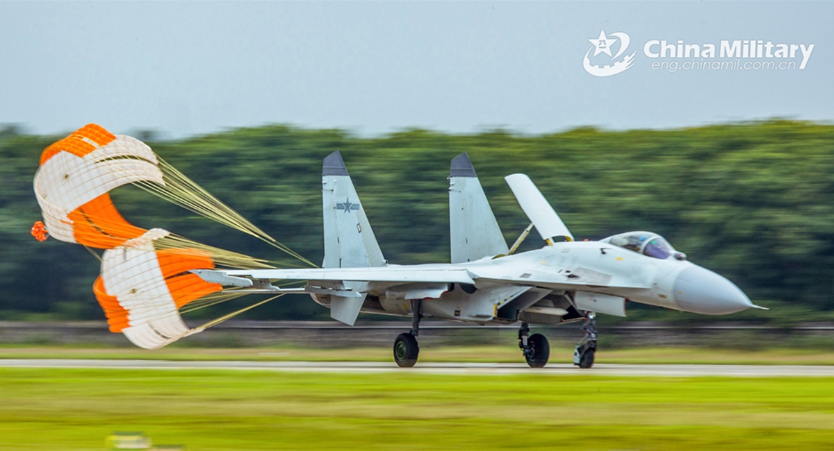 A fighter jet attached to a naval aviation unit under the PLA Southern Theater Command pops a drag parachute to slow down on the runway after completing a multi-subject flight training exercise on June 13, 2024. (eng.chinamil.com.cn/Photo by Fu Jinquan)