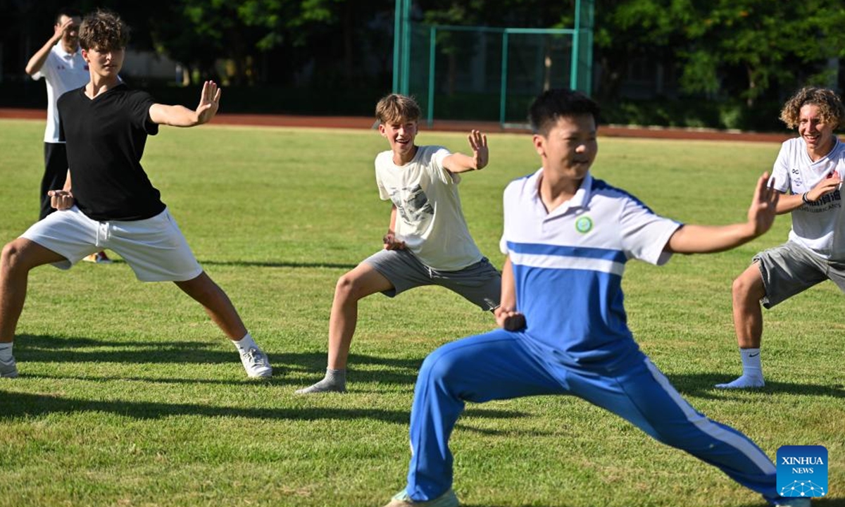 German students try practicing Kungfu at a school in Haikou, south China's Hainan Province, Aug. 7, 2024. German students attending a Sino-German U16 football tournament visited a middle school in Haikou for a study tour on Wednesday. (Photo: Xinhua)