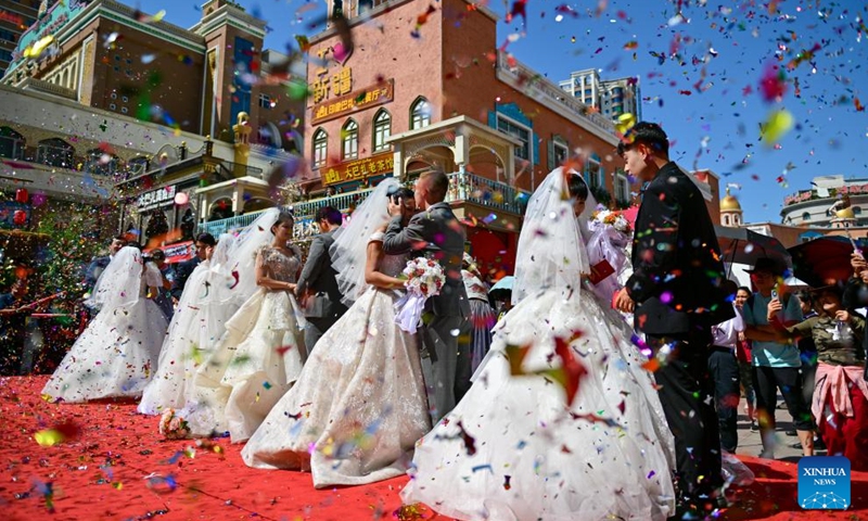 URUMQI, Aug. 10, 2024 (Xinhua) -- Newlywed couples attend a group wedding at the Xinjiang International Grand Bazaar in Urumqi, northwest China's Xinjiang Uygur Autonomous Region, Aug. 10, 2024. The group wedding was held here on Saturday to mark the Qixi Festival, also known as Chinese Valentine's Day. Photo: Xinhua