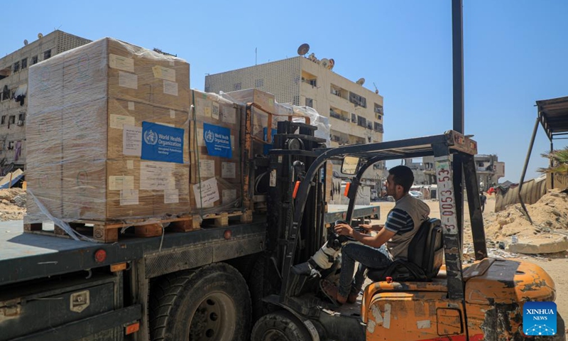 A worker unloads medical aid delivered by the World Health Organization (WHO) at Nasser Hospital in the southern Gaza Strip city of Khan Younis, on Aug. 7, 2024. A seemingly endless cycle of violence-induced displacement is making it increasingly difficult for Gazans to access the assistance they need, UN humanitarians said on Wednesday. (Photo: Xinhua)