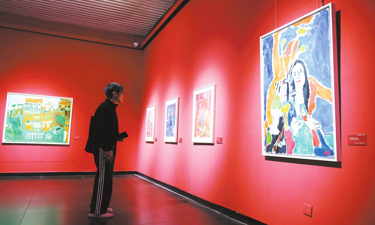 Visitors at the Li Zijian Art Museum explore an oil painting exhibition titled 