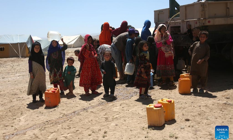 People fetch water from a water tank at a relocation site for flood survivors in Firoz Koh, Ghor province, Afghanistan, July 27, 2024. (Photo: Xinhua)