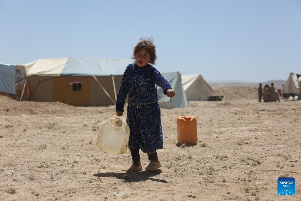 A girl carries a water barrel at a relocation site for flood survivors in Firoz Koh, Ghor province, Afghanistan, July 27, 2024. (Photo: Xinhua)