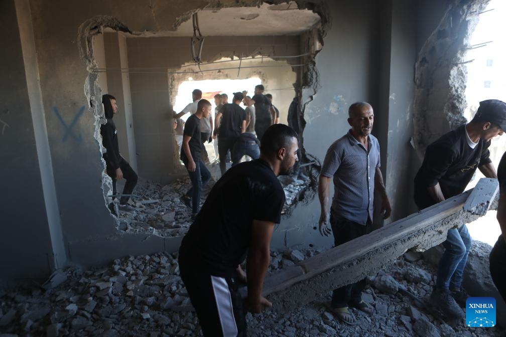 People are seen inside an apartment in a building that was demolished by Israeli forces in West Bank village of Dura near Hebron city, on Aug. 8, 2024. (Photo: Xinhua)