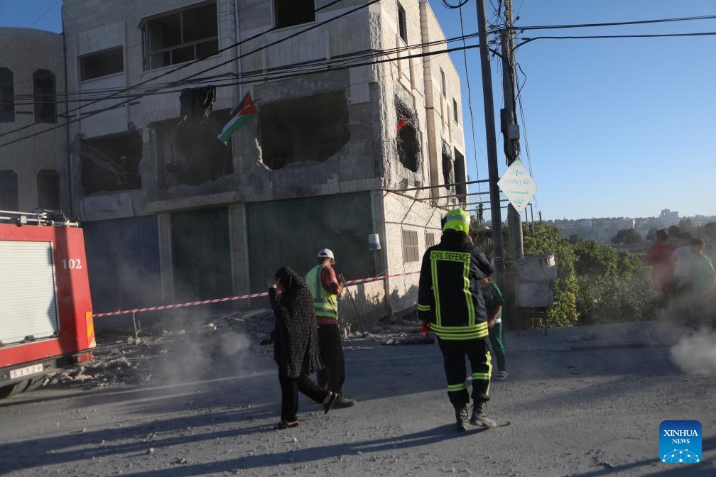 People are seen inside an apartment in a building that was demolished by Israeli forces in West Bank village of Dura near Hebron city, on Aug. 8, 2024. (Photo: Xinhua)