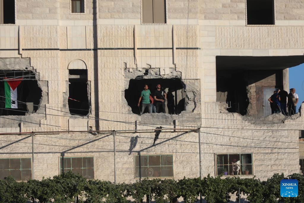 People are seen inside an apartment in a building that was demolished by Israeli forces in West Bank village of Dura near Hebron city, on Aug. 8, 2024. (Photo: Xinhua)