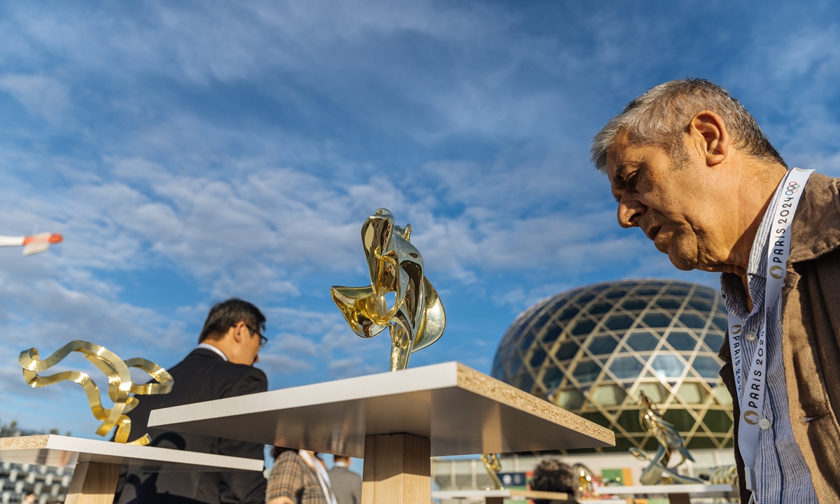 A visitor admires an artwork at the 2024 Olympic Fine Arts Exhibition on Thursday.  Photo: Li Hao/GT