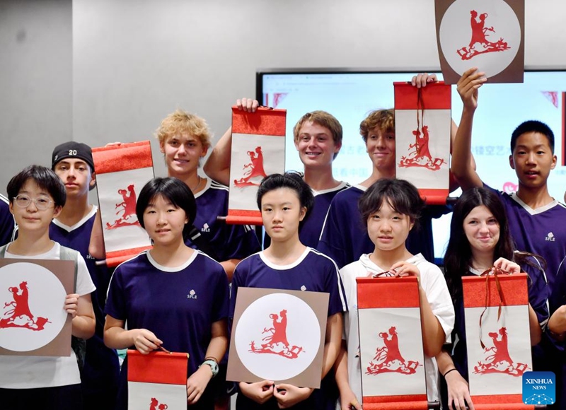 Chinese and American students show their paper cut works featuring the Qixi Festival during a cultural event at Shijiazhuang Foreign Language School in Shijiazhuang, north China's Hebei Province, Aug. 10, 2024. A delegation of middle school students and teachers from US state Iowa took part in a cultural event here on the occasion of the Qixi Festival, also known as Chinese Valentine's Day. Photo: Xinhua