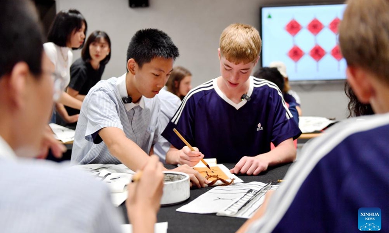 Chinese and American students practice calligraphy during a cultural event at Shijiazhuang Foreign Language School in Shijiazhuang, north China's Hebei Province, Aug. 10, 2024. A delegation of middle school students and teachers from US state Iowa took part in a cultural event here on the occasion of the Qixi Festival, also known as Chinese Valentine's Day. Photo: Xinhua