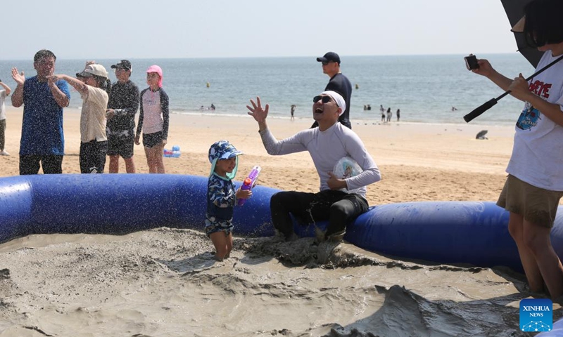 Tourists have fun in a mud bath on a beach in Boryeong, South Korea, Aug. 9, 2024. Photo: Xinhua